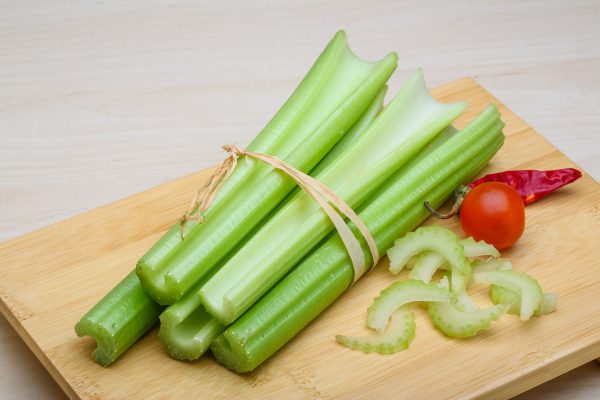 Fresh Green Celery sticks on the wood background